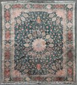 A fine Persian Tabriz carpet with central floral medallion and meandering flowerhead motifs across