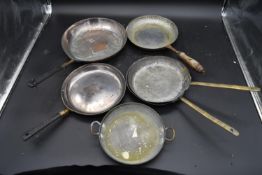 A collection of six various copper and brass pans. H.3.2 Dia.44cm (largest)