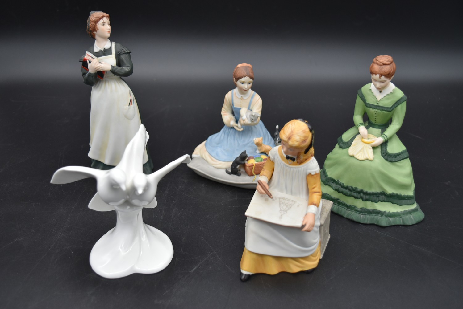 Four franklin porcelain figures from the Little Women series and a Royal Doulton figure group,