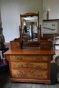 A late 19th century straight grain and burr walnut dressing table with swing bevelled plate above an