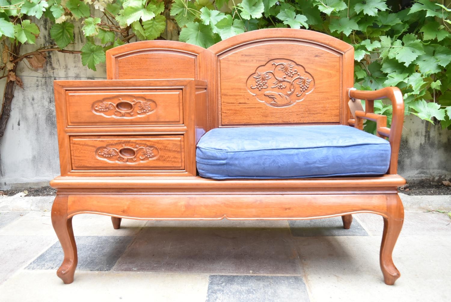 A carved Chinese hardwood hall seat fitted with drawers on cabriole supports. H.79 W.100 D.48cm