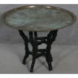 A Benares brass topped occasional table with incised decoration on carved faux bamboo base. H.55 D.
