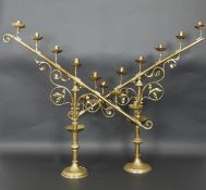 A large pair 19th century brass menorahs of angular form raised on turned scrolling foliate bases.