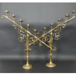 A large pair 19th century brass menorahs of angular form raised on turned scrolling foliate bases.