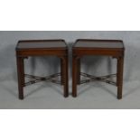 A pair of Georgian style mahogany lamp or bedside tables on chamfered square section pierced