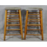 A pair of vintage teak framed vaulting horses or exercise stools with tops upholstered in suede. H.