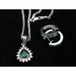 An 18 carat white gold emerald and diamond pendant and chain with emerald and diamond hoop earrings.