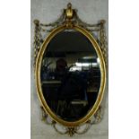 An Adam style gilt and gesso wall mirror with Classical urn and ribbon decoration. H.130 W.70cm