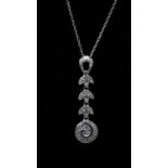 A 14 carat white gold and diamond set articulated foliate design pendant and chain. The pendant is