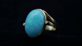 An 18 carat yellow gold amazonite and diamond cocktail ring. Set to centre with an oval cabochon