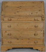 A 19th century pine bureau with fall front revealing a fitted interior above four long graduated