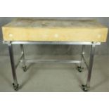 A butchers block on metal trolley base with wheel casters each fitted with a foot brake. H.95 W.