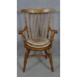 A late 19th century beech framed stick back kitchen armchair on turned stretchered supports. H.99cm