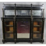 A late Victorian ebonised mirror backed credenza with allover incised gilt carving the bevelled