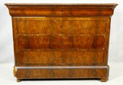 A 19th century French Louis Phillipe figured mahogany commode with marble top above four long