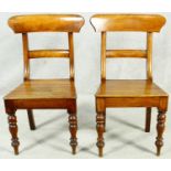A pair of mid Victorian mahogany bar back hall chairs with panel seats on turned tapering bulbous