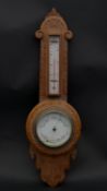 A late Victorian carved light oak banjo barometer thermometer. H.53.5 W.16.5cm