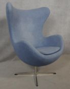 After Arne Jacobsen (1902-1971) Egg chair in pale blue upholstery and rise and fall action on four