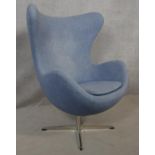 After Arne Jacobsen (1902-1971) Egg chair in pale blue upholstery and rise and fall action on four