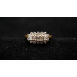 An 18 carat yellow gold and diamond set cluster ring. Set with five rectangular baguette cut