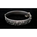 A Georg Jensen engraved silver clip bangle, engraved with a stylised foliate and floral design.