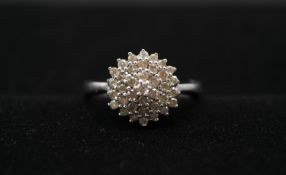 A 9 carat white gold and diamond cluster ring, set with thirty seven round brilliant cut diamonds in