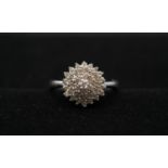 A 9 carat white gold and diamond cluster ring, set with thirty seven round brilliant cut diamonds in