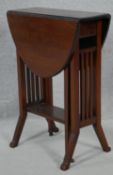A small Edwardian mahogany Sutherland table with pierced end supports on splay feet. H.65 L.71 W.