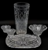 A collection of cut crystal and glass items. Including a large cut crystal vase with geometric