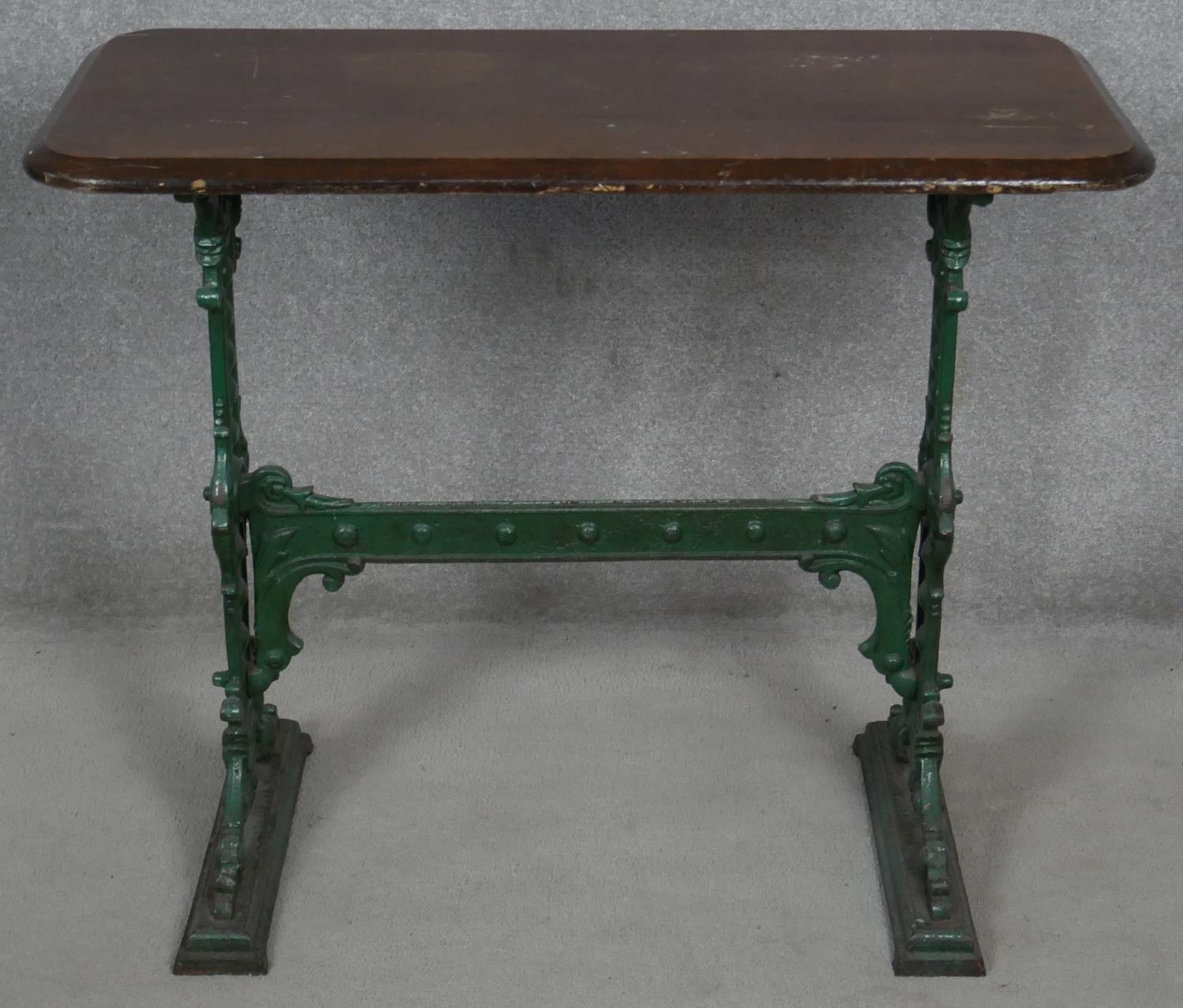 A 19th century cast iron pub table with mahogany top the base marked; Gaskell and Chambers,