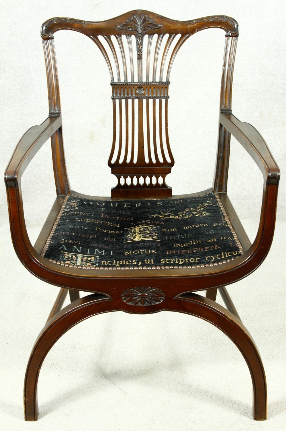 A mahogany Chippendale style X framed armchair with pierced and carved vase shaped back splat. H.