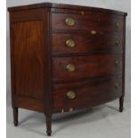 A 19th century mahogany bowfronted chest of four long drawers flanked by reeded pilasters on