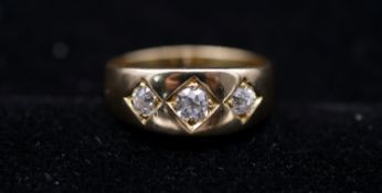 A Victorian 18 carat yellow gold and diamond three stone gypsy ring. Set to centre with a cushion