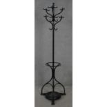 A late 19th century cast iron coat and umbrella stand with lift out drip tray on tripod base. H.