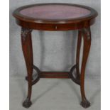 A C.1900 mahogany vitrine with original piped silk lining raised on slender cabriole supports with