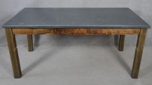 A dining table from reclaimed timbers with metal faced top on square supports. H.76 L.170 W.93cm