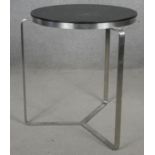 A contemporary designer brushed steel occasional table. H.47 D.39cm