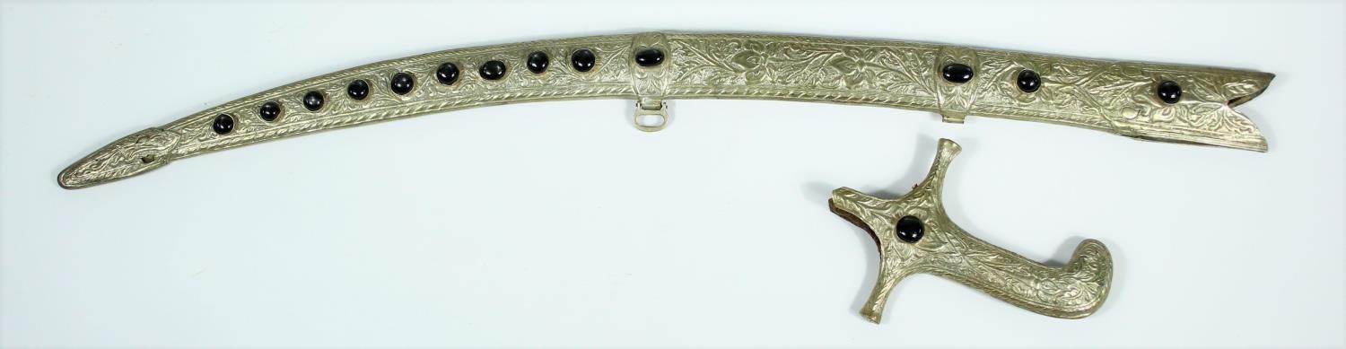 An Indian white metal foliate repousse and floral engraved sword scabbard and hilt set with fourteen