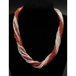 A coral and freshwater pearl multistrand rope necklace with a 14 carat yellow gold diamond and