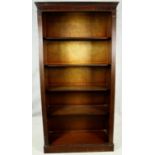 A full height Georgian style mahogany bookcase with open shelves flanked by pilasters on plinth