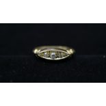 An Edwardian 18 carat yellow gold and diamond five stone ring, set with four round old cut