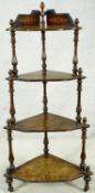 A Victorian burr walnut and ebony with satinwood inlaid corner four tier whatnot on turned supports.