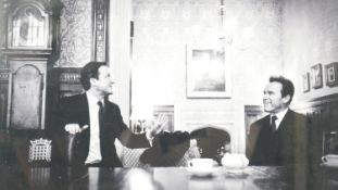 A framed presentation photograph of David Cameron and Arnold Schwarzenegger at Chequers, signed by