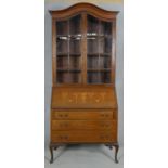 An Edwardian mahogany bureau bookcase with satinwood swag and urn inlay to the fall front raised