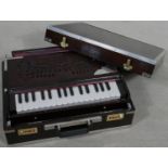 A modern portable harmonium from the Calcutta Harmonium Shop in metal bound hardwood carrying