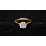 An 18 carat yellow gold and diamond solitaire ring. Set to centre with a round brilliant cut diamond