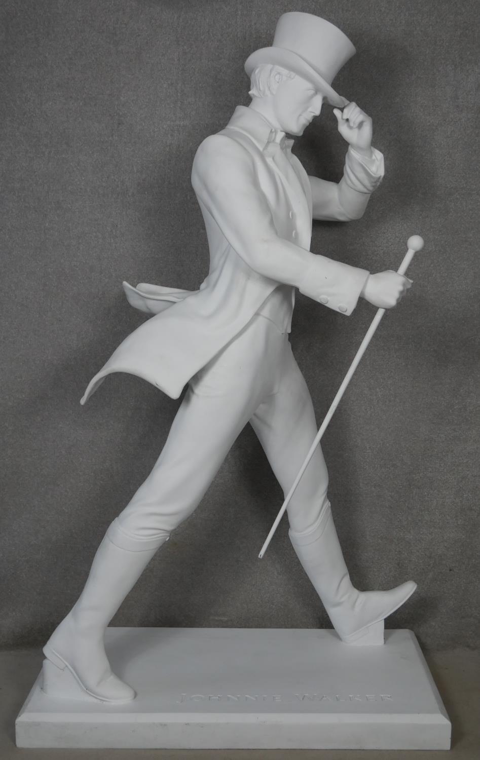 A life size white fibreglass figure of Johnnie Walker on a rectangular base, stamped Johnnie Walker.