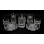 A collection of cut crystal items. Inlcuding a set of eleven side plates with star cut design, three