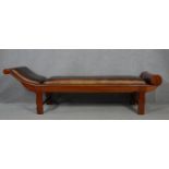 An Eastern teak framed chaise longue in studded leather upholstery. H.66 L.222 W.68cm
