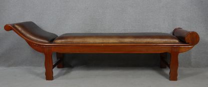 An Eastern teak framed chaise longue in studded leather upholstery. H.66 L.222 W.68cm